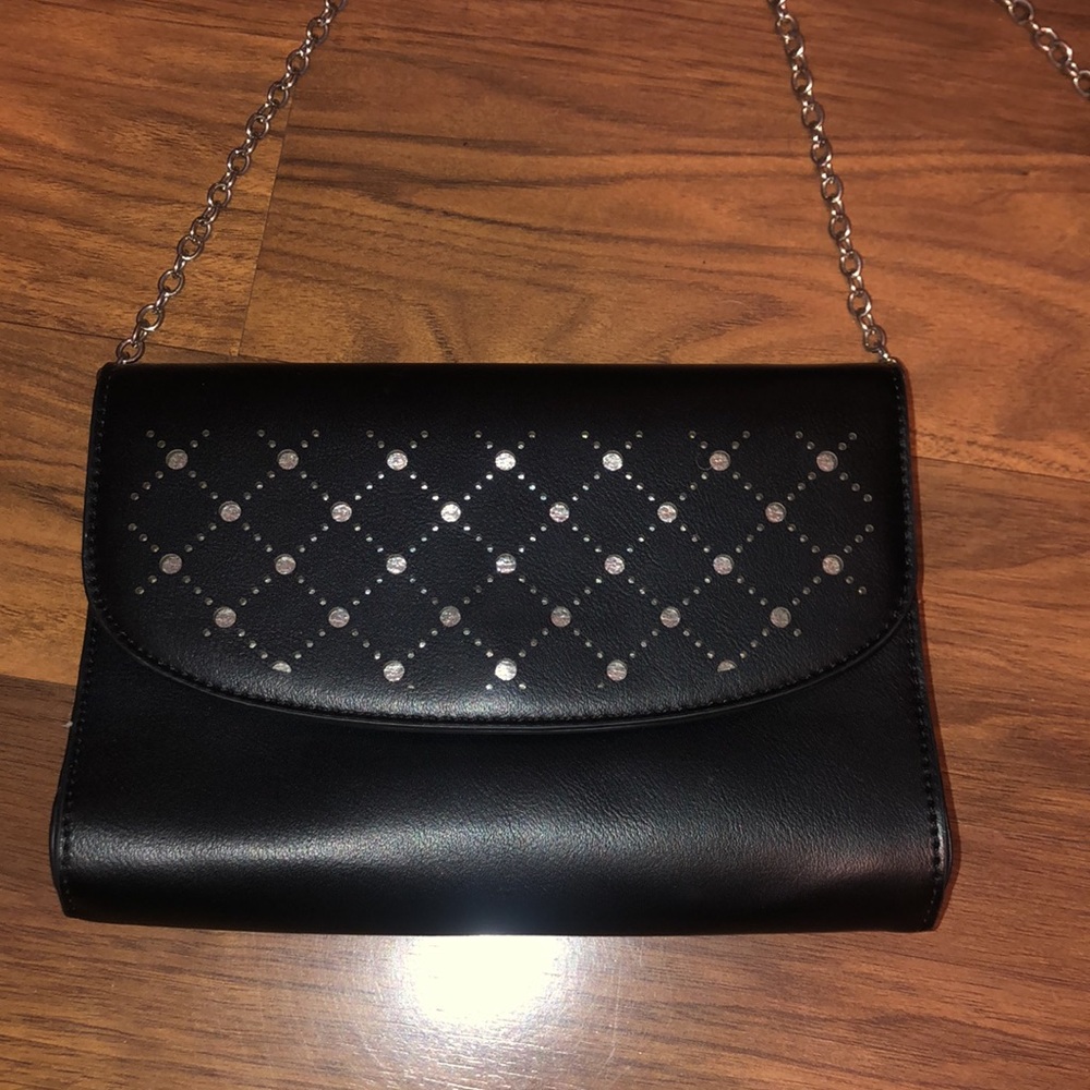 Black clutch converting to shoulder bag with dot design